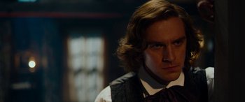 Movie still from “The Man Who Invented Christmas” (2017), directed by Bharat Nalluri – A person with long hair; Close Up shot, Over the shoulder angle