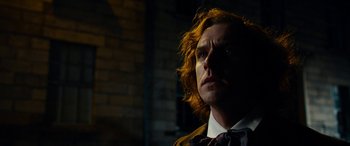 Movie still from “The Man Who Invented Christmas” (2017), directed by Bharat Nalluri – A person wearing a suit and tie; Close Up shot, Low angle