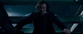 Movie still from “The Man Who Invented Christmas” (2017), directed by Bharat Nalluri – A man with long hair and a bow tie; Medium shot, Low angle