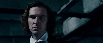 Movie still from “The Man Who Invented Christmas” (2017), directed by Bharat Nalluri – A person wearing a suit and tie; Close Up shot, Low angle