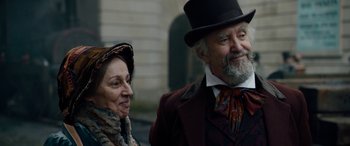 Movie still from “The Man Who Invented Christmas” (2017), directed by Bharat Nalluri – An older man and woman dressed in period clothing; Close Up shot, Over the shoulder angle