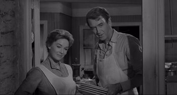 Movie still from “The Man Who Shot Liberty Valance” (1962), directed by John Ford – A man and a woman standing next to each other in a kitchen; Medium shot, Low angle