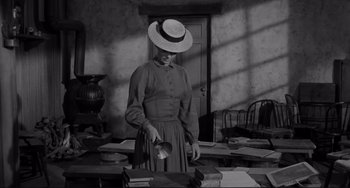 Movie still from “The Man Who Shot Liberty Valance” (1962), directed by John Ford – An old photo of a woman with a hat; Medium shot, High angle