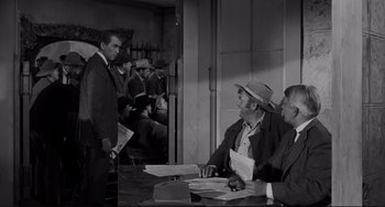 Movie still from “The Man Who Shot Liberty Valance” (1962), directed by John Ford – A group of men sitting around a table; Medium shot, Over the shoulder angle