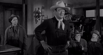 Movie still from “The Man Who Shot Liberty Valance” (1962), directed by John Ford – A black and white photo of john wayne; Medium shot, Over the shoulder angle