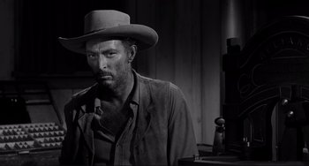Movie still from “The Man Who Shot Liberty Valance” (1962), directed by John Ford – A black and white photo of a man wearing a cowboy hat; Close Up shot, Low angle