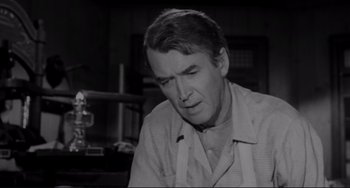 Movie still from “The Man Who Shot Liberty Valance” (1962), directed by John Ford – An older man is looking down at his face; Close Up shot, Low angle