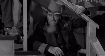 Movie still from “The Man Who Shot Liberty Valance” (1962), directed by John Ford – An old man with a hat and a beard; Medium shot, High angle