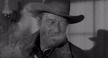 Movie still from “The Man Who Shot Liberty Valance” (1962), directed by John Ford – A black and white photo of a man in a cowboy hat; Close Up shot, Low angle