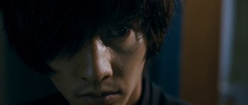 A young man's face with dark hair