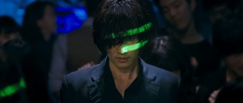 A man with a green light in his hair