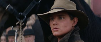Movie still from “The Man from Snowy River” (1982), directed by George Miller – A person wearing a hat; Close Up shot, Low angle