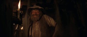 Movie still from “The Man from Snowy River” (1982), directed by George Miller – An old man with a long beard wearing a cowboy hat; Close Up shot, Low angle