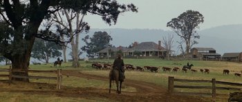 Movie still from “The Man from Snowy River” (1982), directed by George Miller – A man on a horse herds a herd of cattle; Extreme Wide shot, Low angle