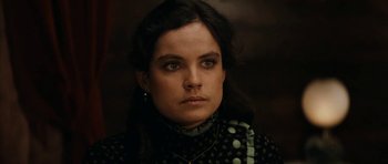 Movie still from “The Man from Snowy River” (1982), directed by George Miller – A person wearing a black and white shirt; Close Up shot, Low angle