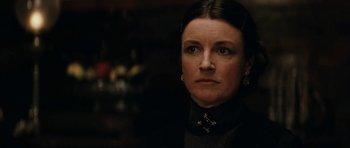 Movie still from “The Man from Snowy River” (1982), directed by George Miller – A person wearing a black shirt; Close Up shot, Over the shoulder angle