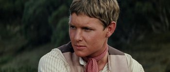 Movie still from “The Man from Snowy River” (1982), directed by George Miller – A person wearing a neck tie; Close Up shot, High angle