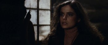 Movie still from “The Man from Snowy River” (1982), directed by George Miller – A woman with long brown hair wearing a black jacket; Close Up shot, Over the shoulder angle