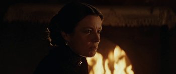Movie still from “The Man from Snowy River” (1982), directed by George Miller – A person in front of a fireplace; Close Up shot, Over the shoulder angle