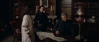 Movie still from “The Man from Snowy River” (1982), directed by George Miller – A man and a woman sitting at a dinner table; Medium shot, Low angle