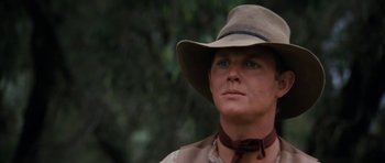 Movie still from “The Man from Snowy River” (1982), directed by George Miller – A man wearing a hat looking into the distance; Close Up shot, Low angle
