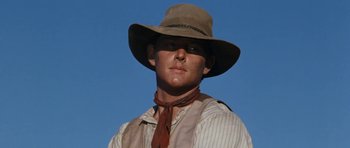 Movie still from “The Man from Snowy River” (1982), directed by George Miller – A man wearing a cowboy hat and a neck tie; Close Up shot, Low angle