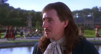 Movie still from “The Man in the Iron Mask” (1998), directed by Randall Wallace – A person with long brown hair; Close Up shot, Over the shoulder angle