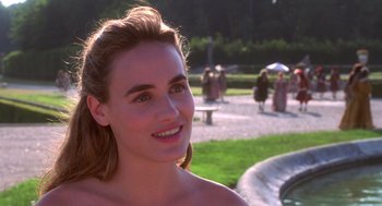 Movie still from “The Man in the Iron Mask” (1998), directed by Randall Wallace – A beautiful young lady standing in front of a fountain; Close Up shot, Over the shoulder angle