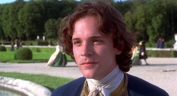 Movie still from “The Man in the Iron Mask” (1998), directed by Randall Wallace – A young man in a blue jacket and a yellow tie; Close Up shot, Over the shoulder angle
