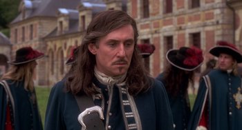 Movie still from “The Man in the Iron Mask” (1998), directed by Randall Wallace – A person with long brown hair; Close Up shot, Over the shoulder angle