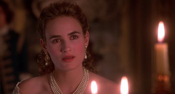 Movie still from “The Man in the Iron Mask” (1998), directed by Randall Wallace – A beautiful woman with a necklace and a candle; Close Up shot, Over the shoulder angle