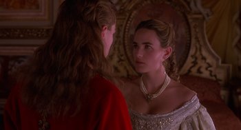 Movie still from “The Man in the Iron Mask” (1998), directed by Randall Wallace – A woman in a red dress looking into a mirror; Close Up shot, Over the shoulder angle