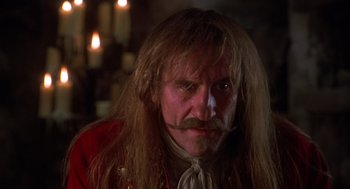 Movie still from “The Man in the Iron Mask” (1998), directed by Randall Wallace – A person with long hair; Close Up shot, Low angle