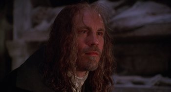 Movie still from “The Man in the Iron Mask” (1998), directed by Randall Wallace – A person with long curly hair; Close Up shot, Low angle