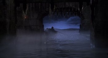 Movie still from “The Man in the Iron Mask” (1998), directed by Randall Wallace – A man is in a boat in the middle of the night; Extreme Wide shot, High angle