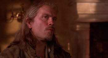 Movie still from “The Man in the Iron Mask” (1998), directed by Randall Wallace – A person with long hair and a beard; Close Up shot, Low angle