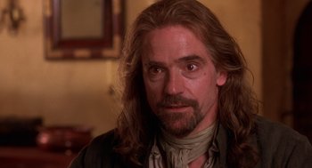 Movie still from “The Man in the Iron Mask” (1998), directed by Randall Wallace – A person with long hair and a beard; Close Up shot, Over the shoulder angle