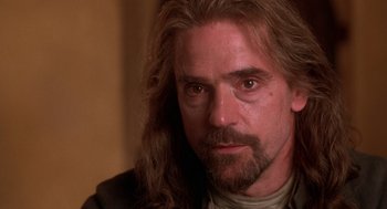 Movie still from “The Man in the Iron Mask” (1998), directed by Randall Wallace – A person with long hair and a beard; Close Up shot, Low angle