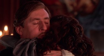 Movie still from “The Man in the Iron Mask” (1998), directed by Randall Wallace – A man with long hair is kissing a woman's face; Close Up shot, Over the shoulder angle