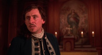 Movie still from “The Man in the Iron Mask” (1998), directed by Randall Wallace – A man in a military uniform standing in front of a painting; Close Up shot, Over the shoulder angle