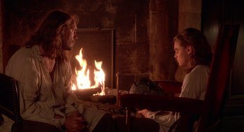 Movie still from “The Man in the Iron Mask” (1998), directed by Randall Wallace – A man and a woman sitting in front of a fireplace; Medium shot, Over the shoulder angle