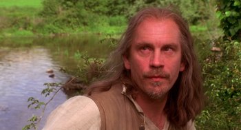 Movie still from “The Man in the Iron Mask” (1998), directed by Randall Wallace – A person with long hair near a body of water; Close Up shot, Over the shoulder angle