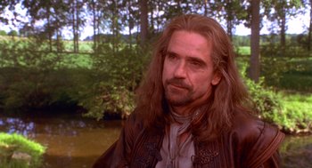 Movie still from “The Man in the Iron Mask” (1998), directed by Randall Wallace – A person with long hair and a beard; Close Up shot, Over the shoulder angle