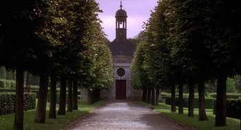Movie still from “The Man in the Iron Mask” (1998), directed by Randall Wallace – A path leading to a church with trees in front of it; Extreme Wide shot, Low angle