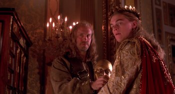 Movie still from “The Man in the Iron Mask” (1998), directed by Randall Wallace – A man and a woman holding a mask in a room; Medium shot, Low angle