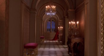 Movie still from “The Man in the Iron Mask” (1998), directed by Randall Wallace – A room with a lot of lights and chandeliers in it; Extreme Wide shot, High angle