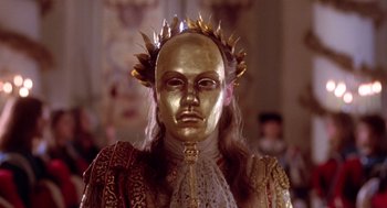 Movie still from “The Man in the Iron Mask” (1998), directed by Randall Wallace – A person with a gold mask and a crown; Close Up shot, Low angle