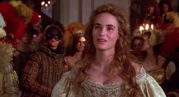 Movie still from “The Man in the Iron Mask” (1998), directed by Randall Wallace – A woman in a white dress and a crowd of people in costumes; Close Up shot, Over the shoulder angle