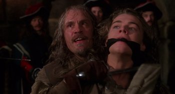 Movie still from “The Man in the Iron Mask” (1998), directed by Randall Wallace – A man and a woman with their mouths taped shut; Close Up shot, Over the shoulder angle