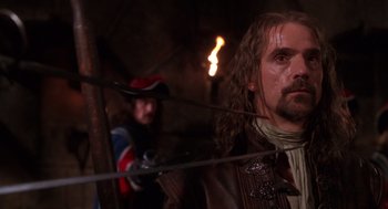 Movie still from “The Man in the Iron Mask” (1998), directed by Randall Wallace – A man with a beard and a sword in his hands; Close Up shot, Low angle